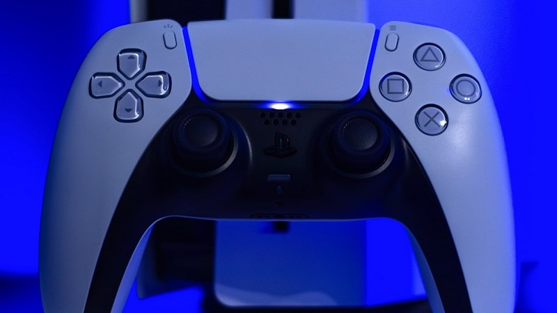 The DualSense controller in front of the PS5