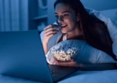 Female eating popcorn and watching film