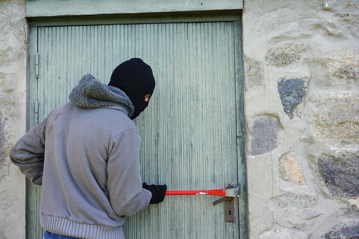 un cambrioleur en train de forcer une porte